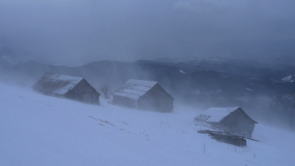 Snowstorm in Winter Mountains