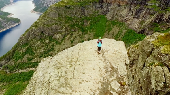 Girl Is Standing on the Edge of the Trolltunga