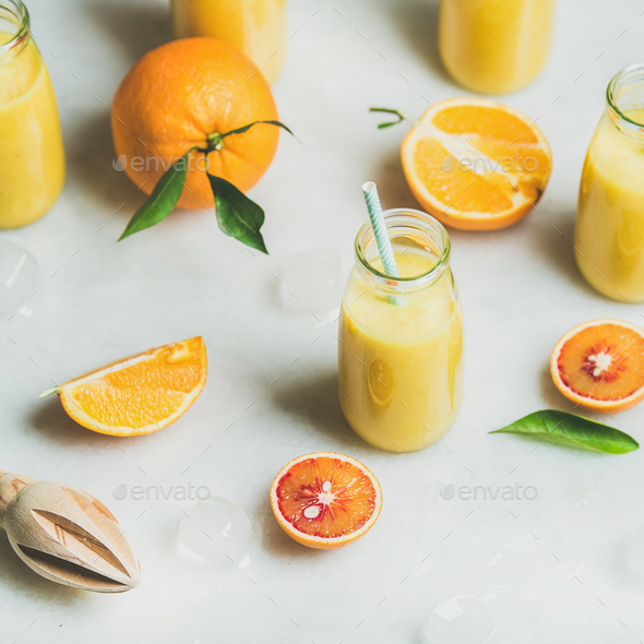 Healthy yellow smoothie with citrus fruit, square crop - Stock Photo - Images