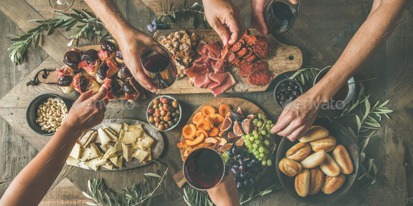 Top view of people drinking, eating together and holding glasses - Stock Photo - Images