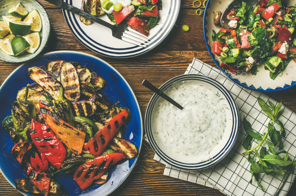 Flat-lay of vegan dinner table setting with healthy appetizers - Stock Photo - Images