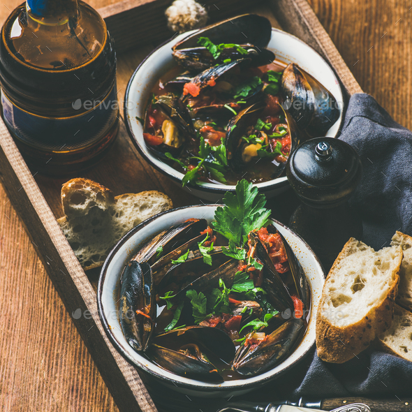 Belgian boiled mussels in and light beer in bottle - Stock Photo - Images