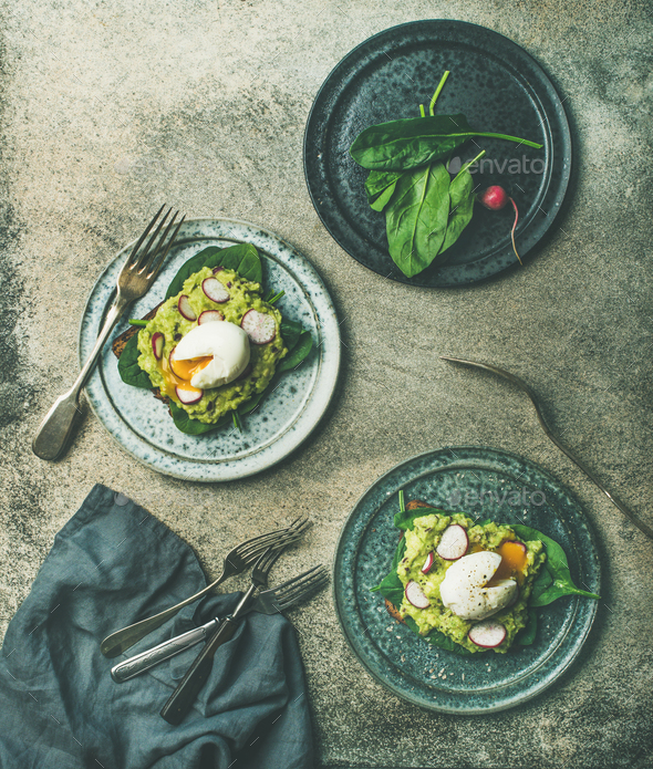 Healthy vegetarian wholegrain avocado toasts with poached egg - Stock Photo - Images