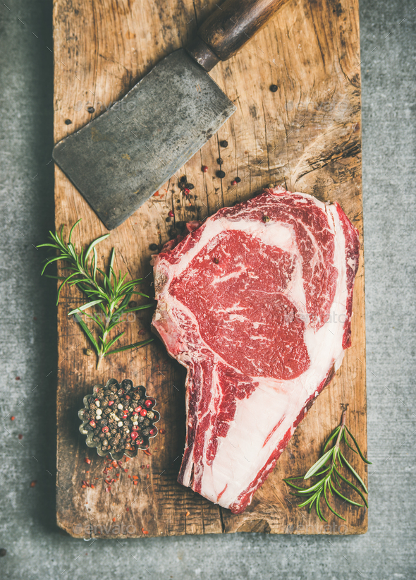 Raw prime beef meat dry-aged steak rib-eye and chopping knife - Stock Photo - Images
