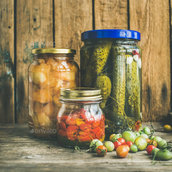 Autumn seasonal pickled vegetables and fruit in jars, square crop - Stock Photo - Images