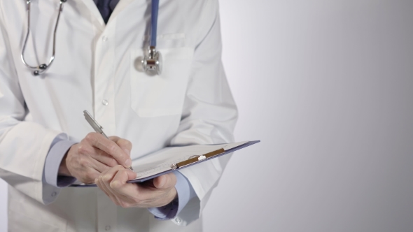 Doctor Filling Out a Medical Chart Document or Patient Examination Notes