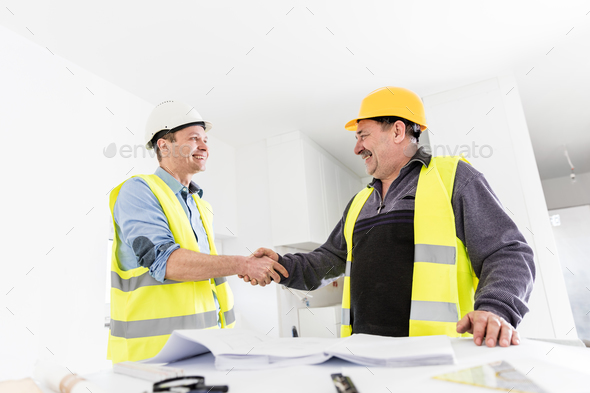 Architect and construction engineer handshake.