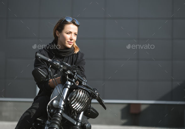 biker woman sitting on motorcycle