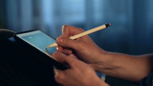 Designer Create a Sketch on His Tablet Using a Stylus at Home