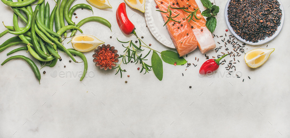Flat-lay of raw salmon fillet steaks with vegetables, greens - Stock Photo - Images