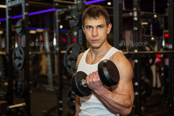 Young muscular man in gym