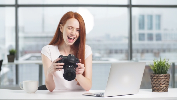 Emotional Redhead Girl Holding Camera and Laughing Looking at Camera alt