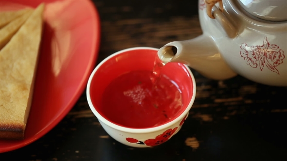 Pour Tea Into a Bowl From Teapot