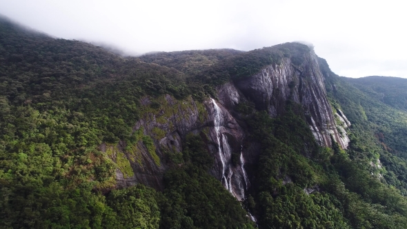 Aerial View in Motion of Waterfall and Forest in Mountains on Adam Peak in Sri Lanka