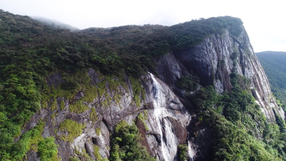 Aerial Top Shot in Motion of Mountains Waterfall on Adam Peak in Sri Lanka