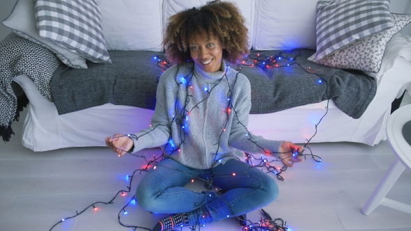 Woman Wrapped in Blue Blinking Garland alt