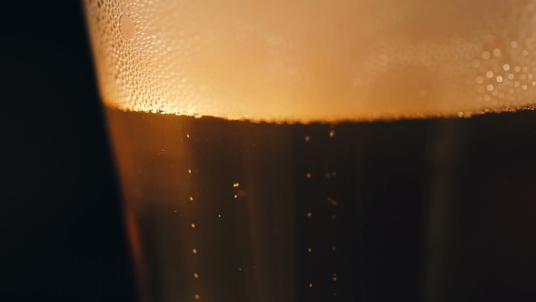 Bubbles Movement inside a Large Glass Mug with Fresh Beer