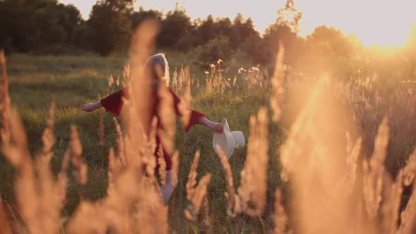 Portrait of Positive Smiling Woman Looking Into Camera at Sunset alt