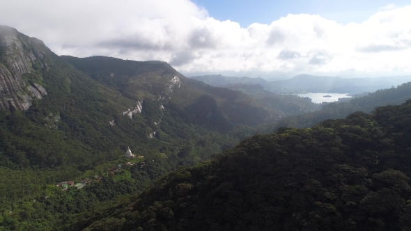 Aerial View in Motion the Wooded Mountains of Adam Peak and Settlement Between Them in Sri Lanka alt
