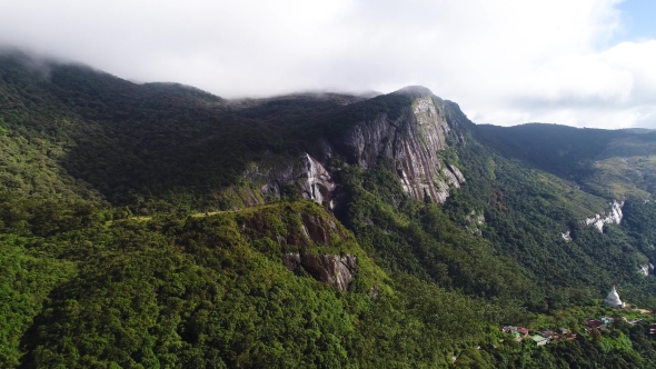 Aerial View of Mountains, Forest and Waterfall Covered with Clouds on Adam's Peak in Sri Lanka alt
