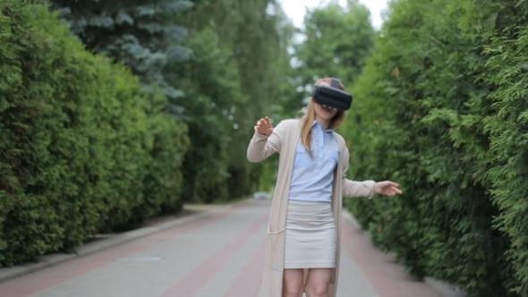 Portrait of Young Beautiful Woman Using 3d Viewer Outdoor in the City with Head Phones- Technology