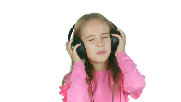 Baby Listens To the Music in the Headphones. White Background alt