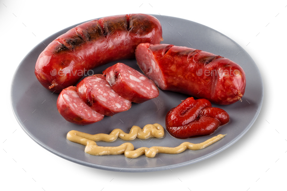 Sliced roasted sausages on gray plate with ketchup - Stock Photo - Images
