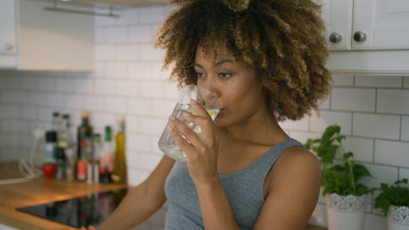 Woman Drinking Fresh Water at Home alt