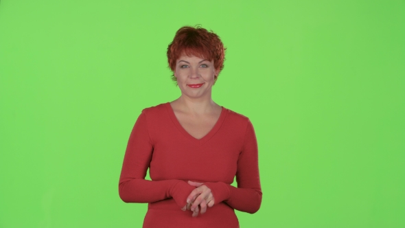 Redhaired Woman Advertises the Products and Shows a Thumbs Up. Green Screen alt