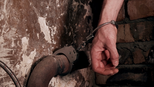 Man Handcuffed To a Pipe in an Old Building alt