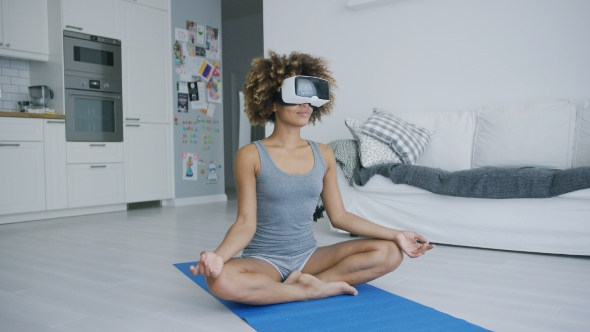 Content Woman Meditating in VR Glasses alt