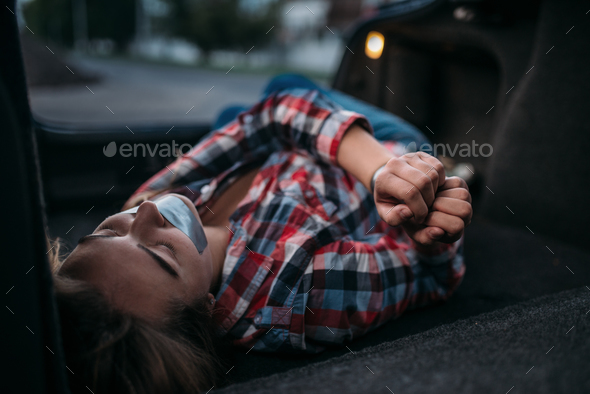 Victim of maniac in trunk, mouth sealed with tape Stock Photo by NomadSoul1