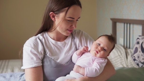 Happy Mother Looking at Her Newborn Baby