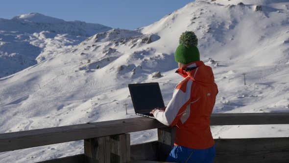 Woman with Laptop in the Ski Resort