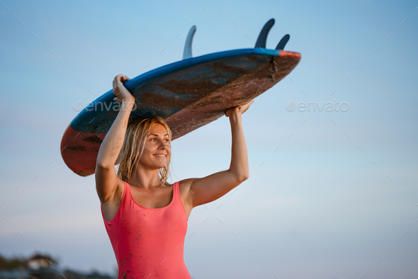 Woman with a surfboard - Stock Photo - Images