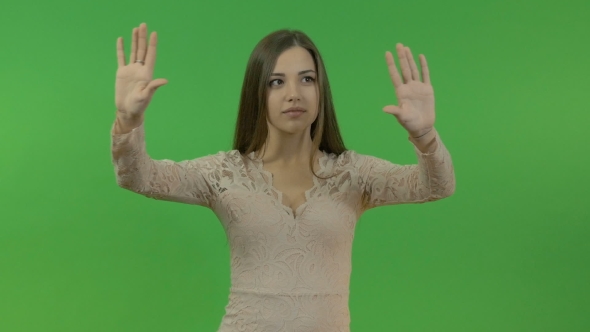 Beautiful Young Girl Doing Hand Gestures on a Green Screen Background.