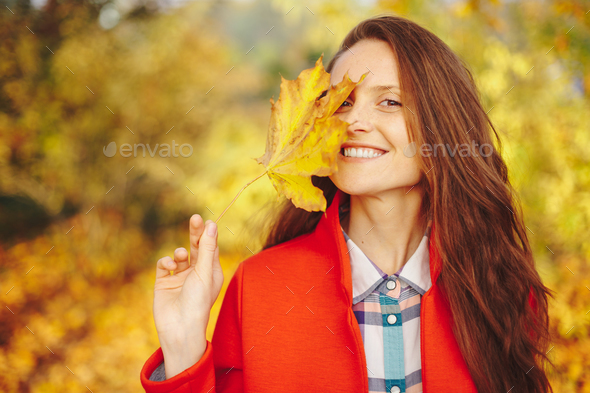 Beautiful young woman with long wavy hair covering face with a l - Stock Photo - Images