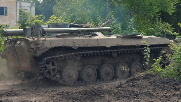 Military Tank Moving on Background Destroy Building During Hostilities alt