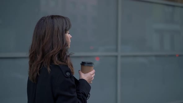 Slow Motion Profile of Business Woman in Sunglasses with a Cup of Coffee