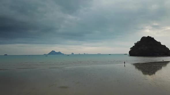 Calm Shallow Beach with Reflections in Thailand alt
