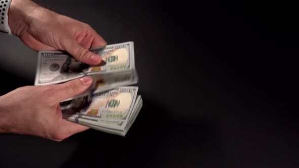 Closeup Hands Currency Counting Dollars and Giving to Another Person
