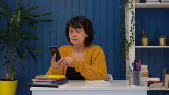 Middle Aged Woman Using Phone at Home