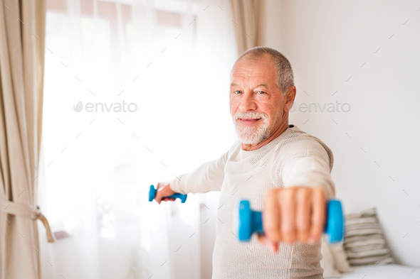 Senior man doing exercise at home.