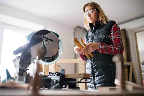 Young woman worker in the carpenter workroom. - Stock Photo - Images