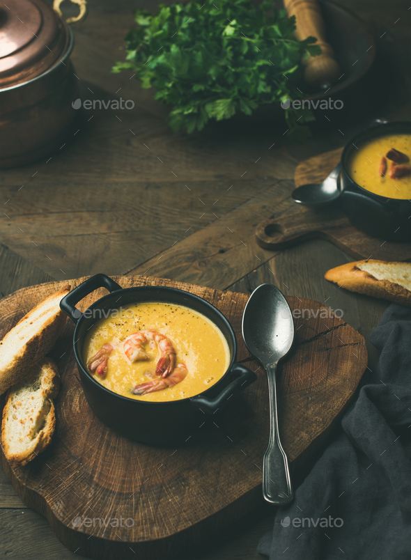 Corn creamy soup with shrimps served in individual pots - Stock Photo - Images