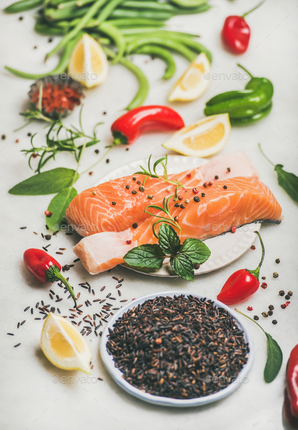 Raw salmon steaks with vegetables, greens and rice, marble background - Stock Photo - Images