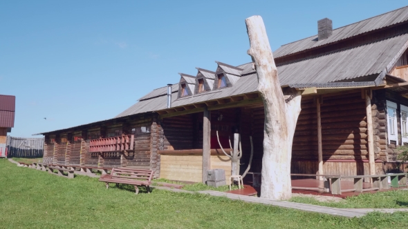 Old Russian Wooden House with Wooden Bench in Front of It