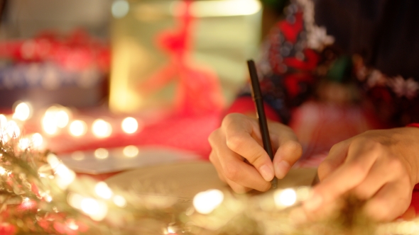 A Girl Is Writing a Letter To Santa Claus in New Years Eve alt