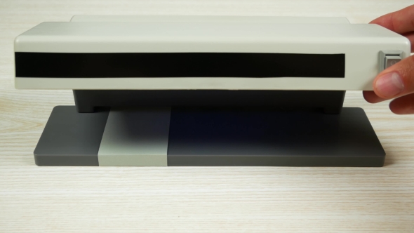 Banknote Denomination of 50 Euros Under the Lamp of the Detector alt