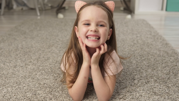 Happy Little Girl on Floor at Home